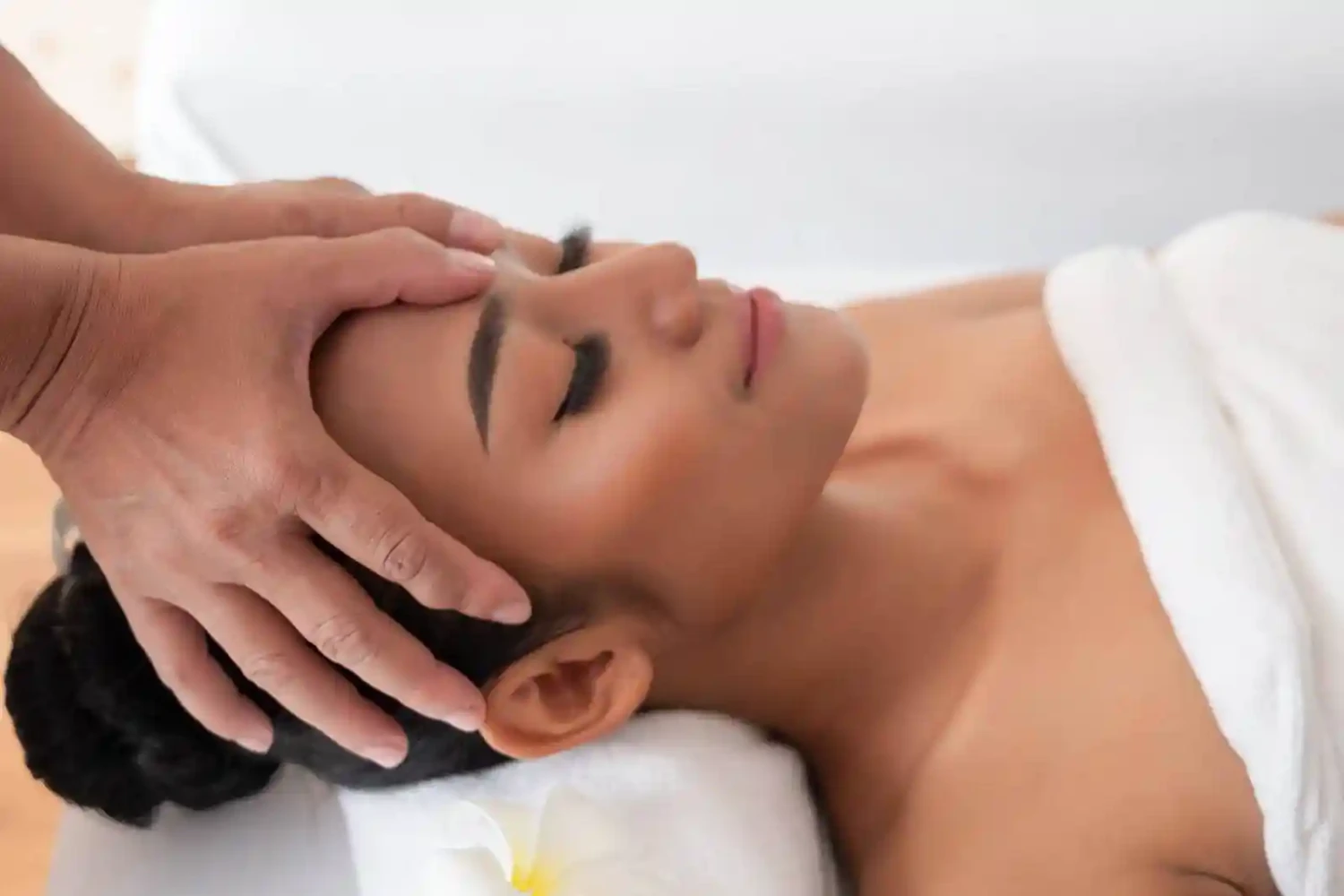 Woman receiving head massage